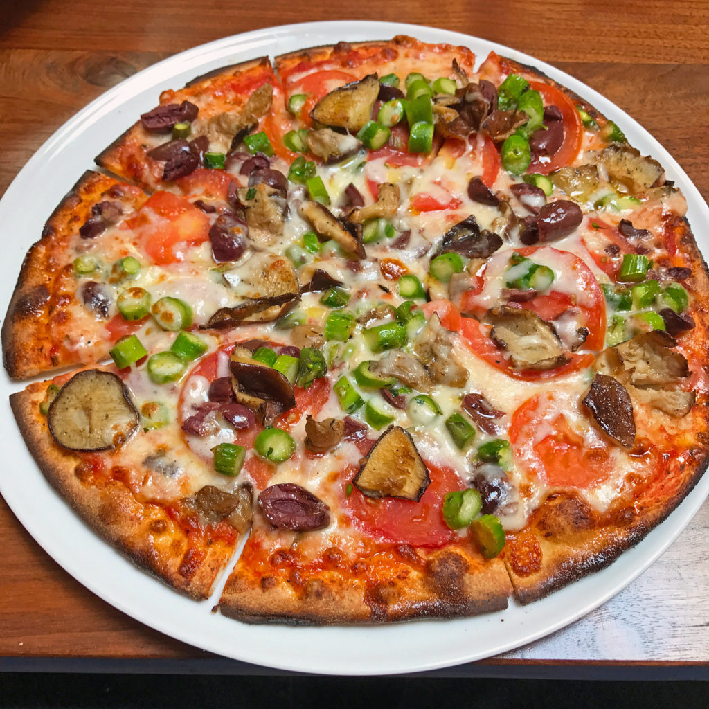 Noosh Nosh’s veggie pizza with tomatoes, mushrooms, black olives and asparagus.