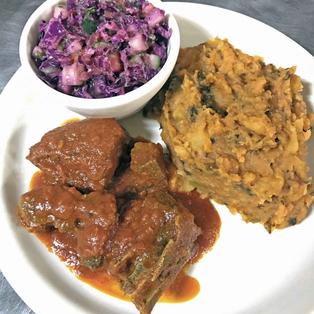 Goat meat, asaro and kachumbari slaw at Funmi’s.