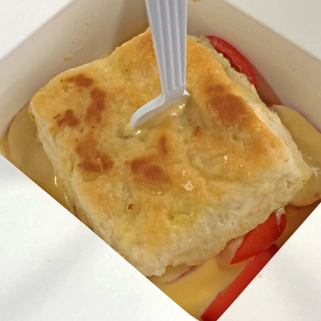 The cheesy ‘mato biscuit at Boujie Biscuit boasts a thick, house-made four-cheese sauce.