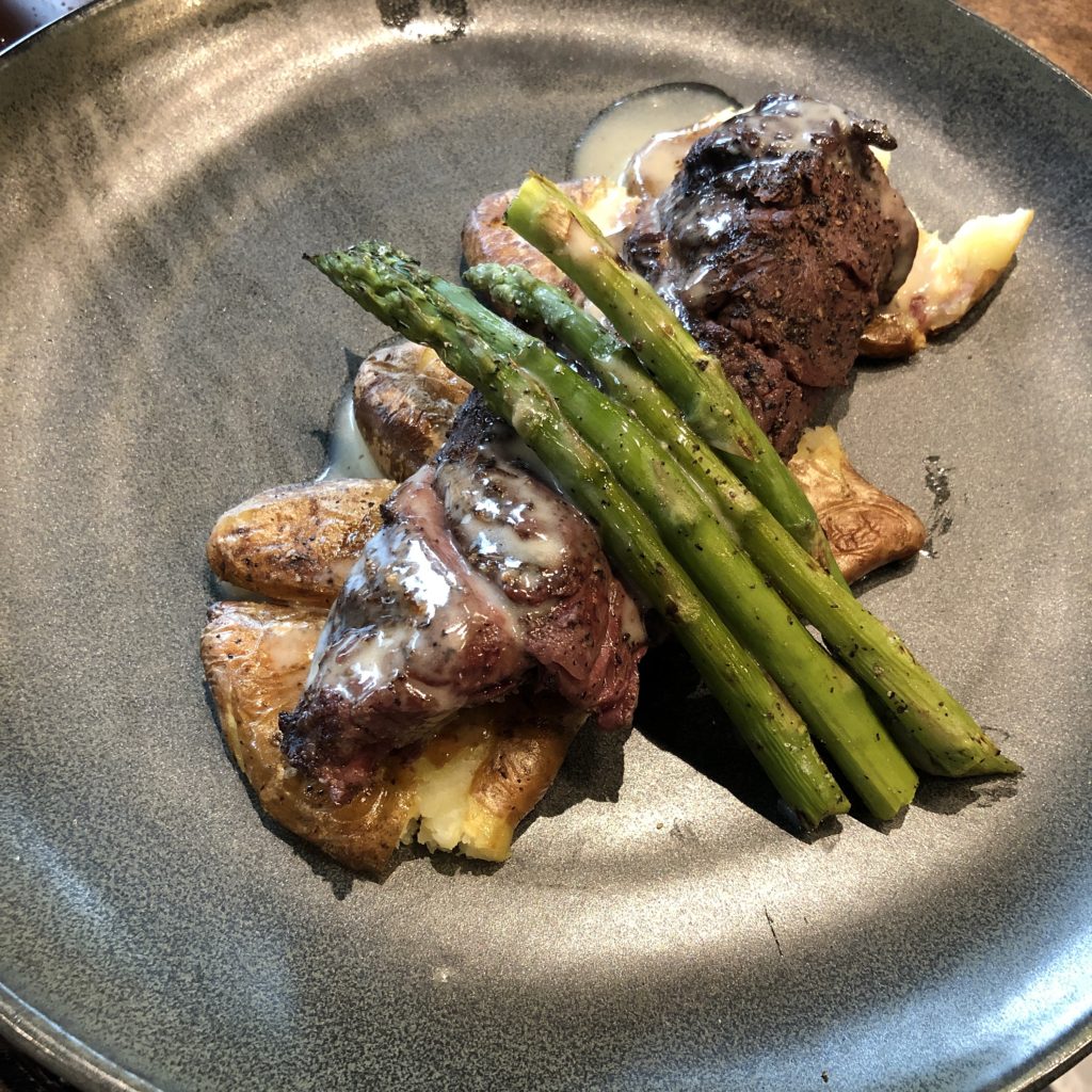 The 502 Bar & Bistro’s bistro steak, a medium-rare steak served with fingerling potatoes, asparagus, and brown butter beurre blanc.