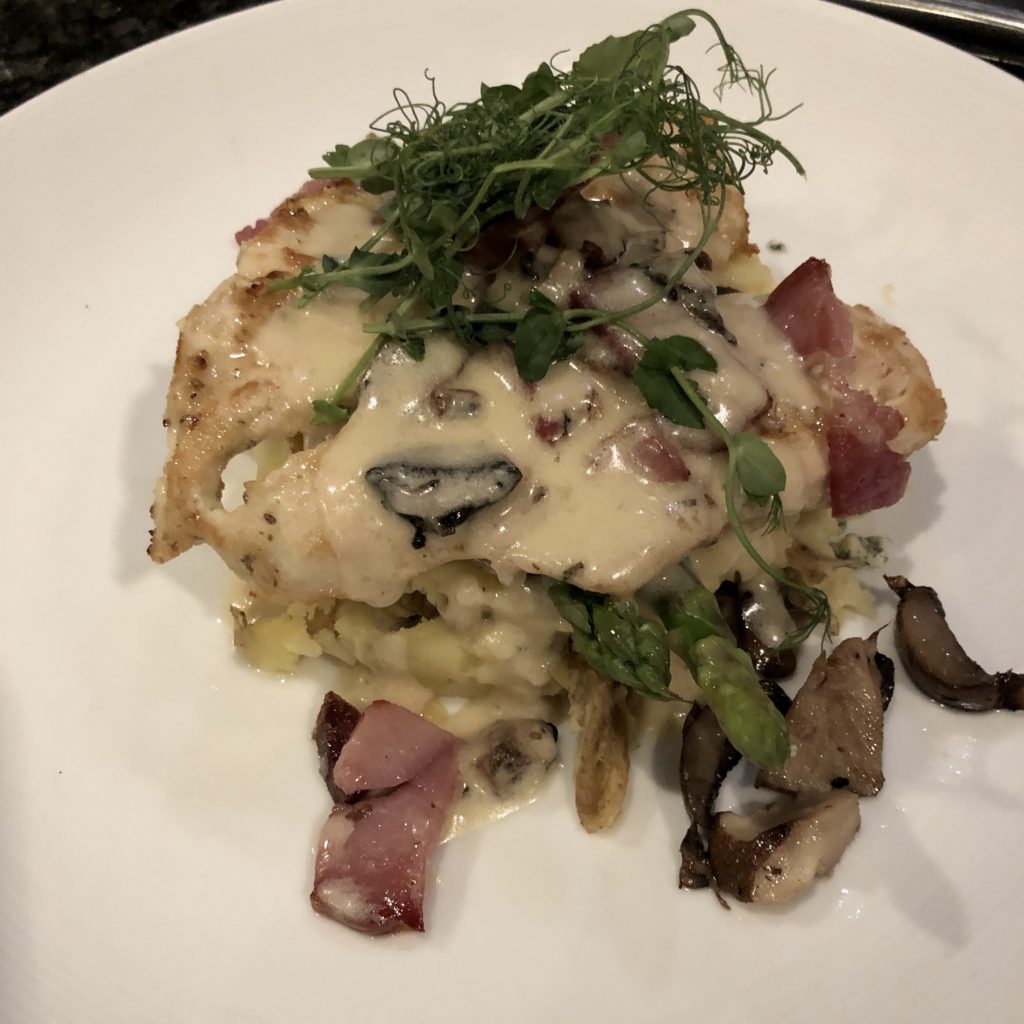 Mesh’s Amish chicken entree is plated with prosciutto and blue cheese.