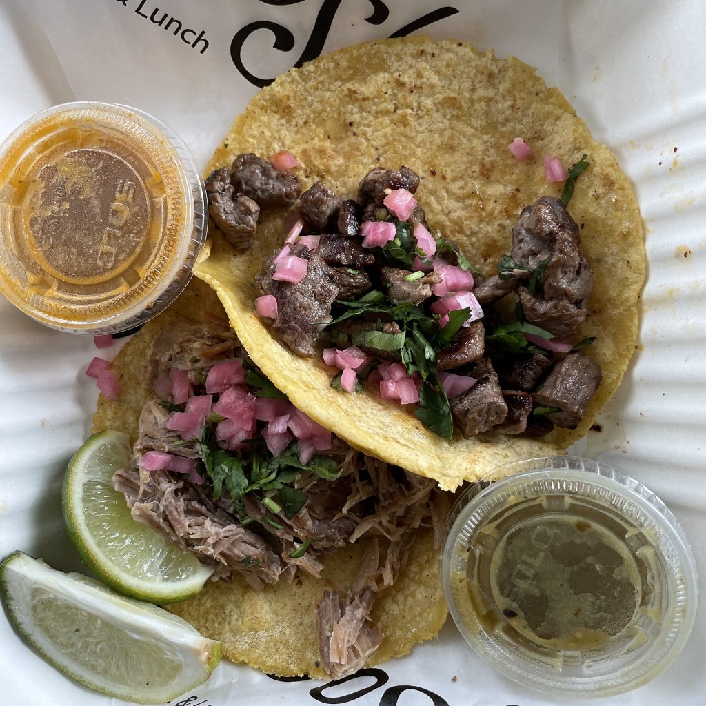 Two of a set of three street tacos on maiz (corn) tortillas at Con Huevos: Slow-roasted pork carnitas (top) and sirloin steak carne asada.